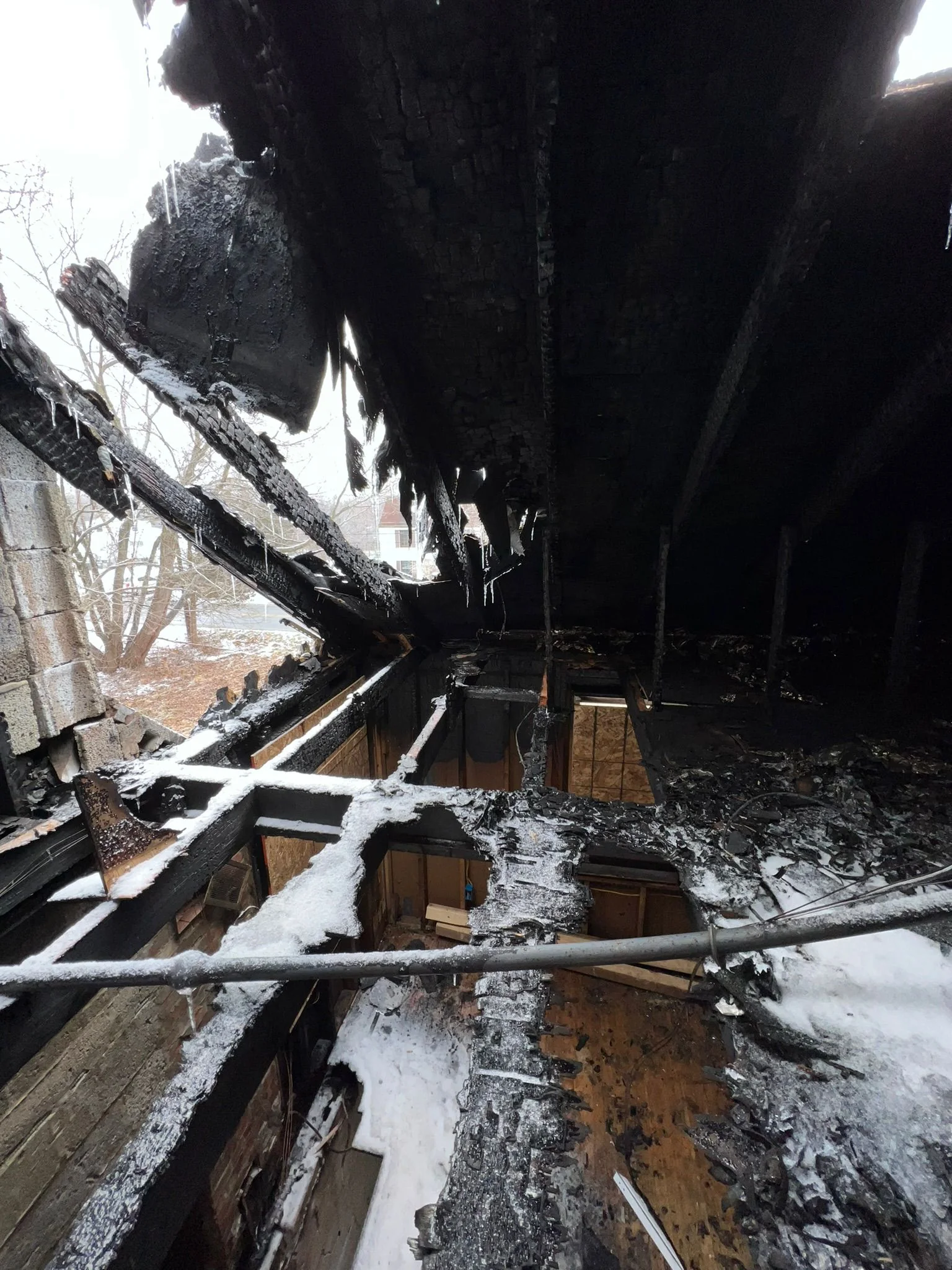 Severe roof and structural fire damage at 15 Riley Road