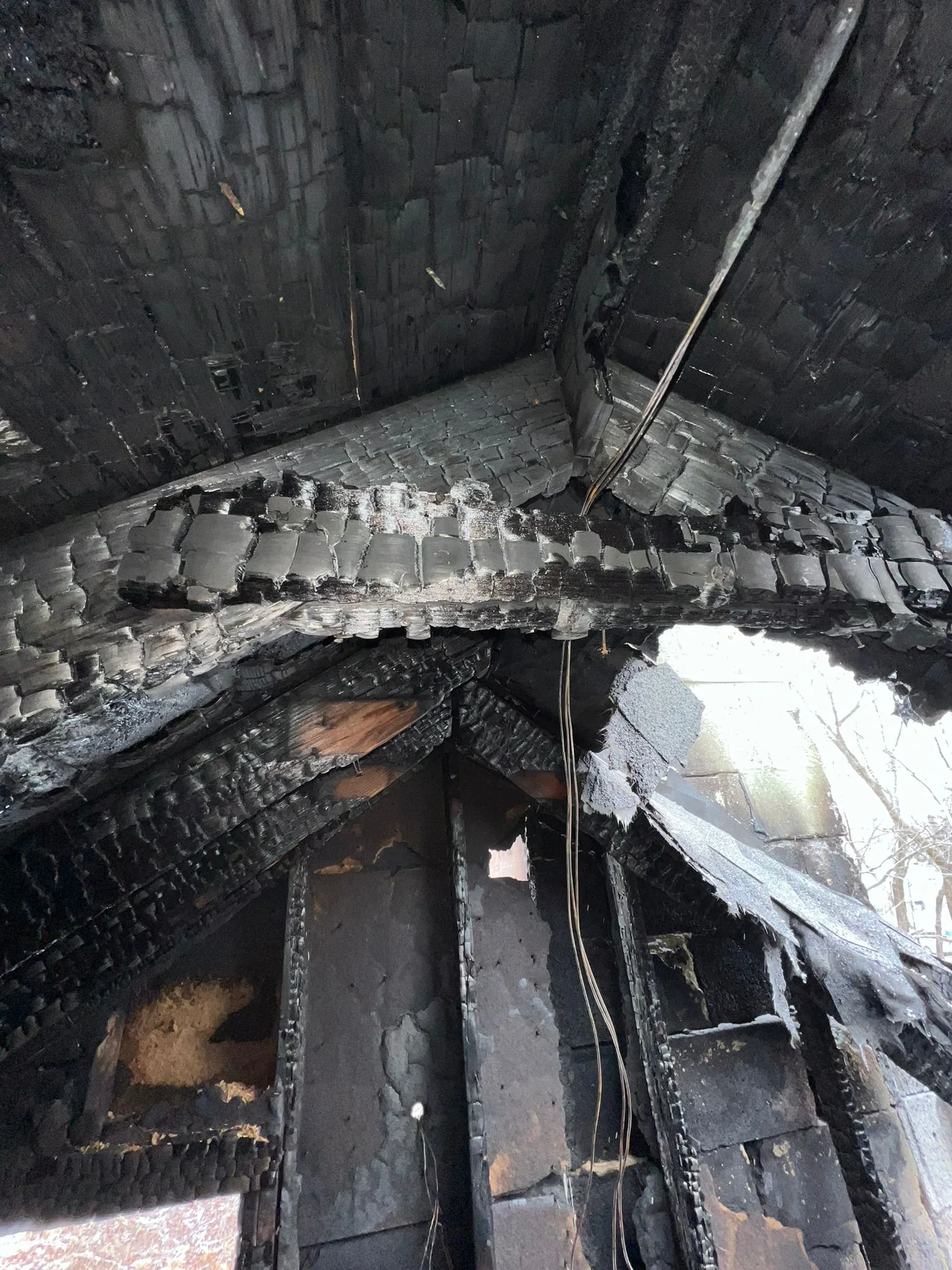 Charred roof framing at 15 Riley Road