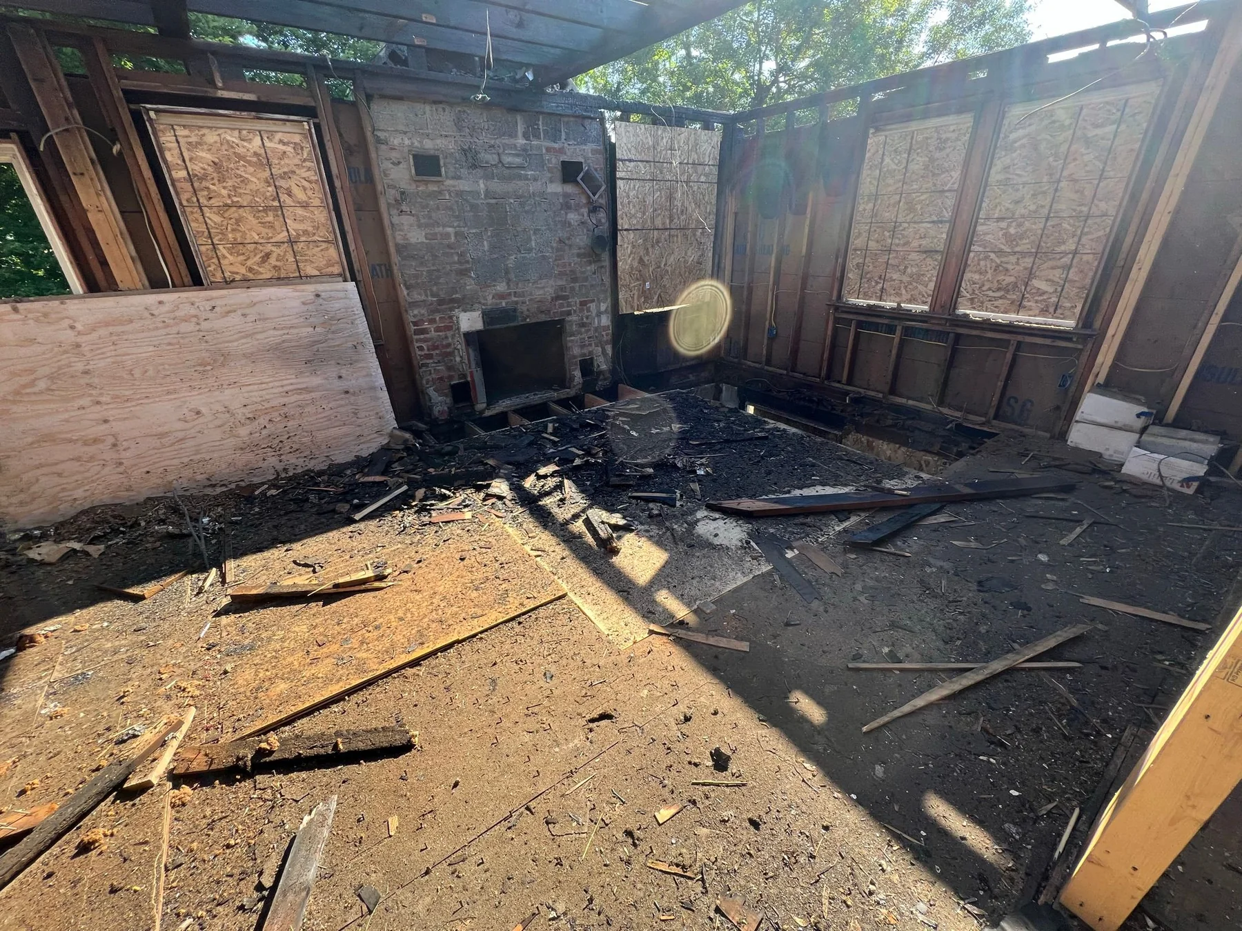 Fire-damaged living area and original fireplace
