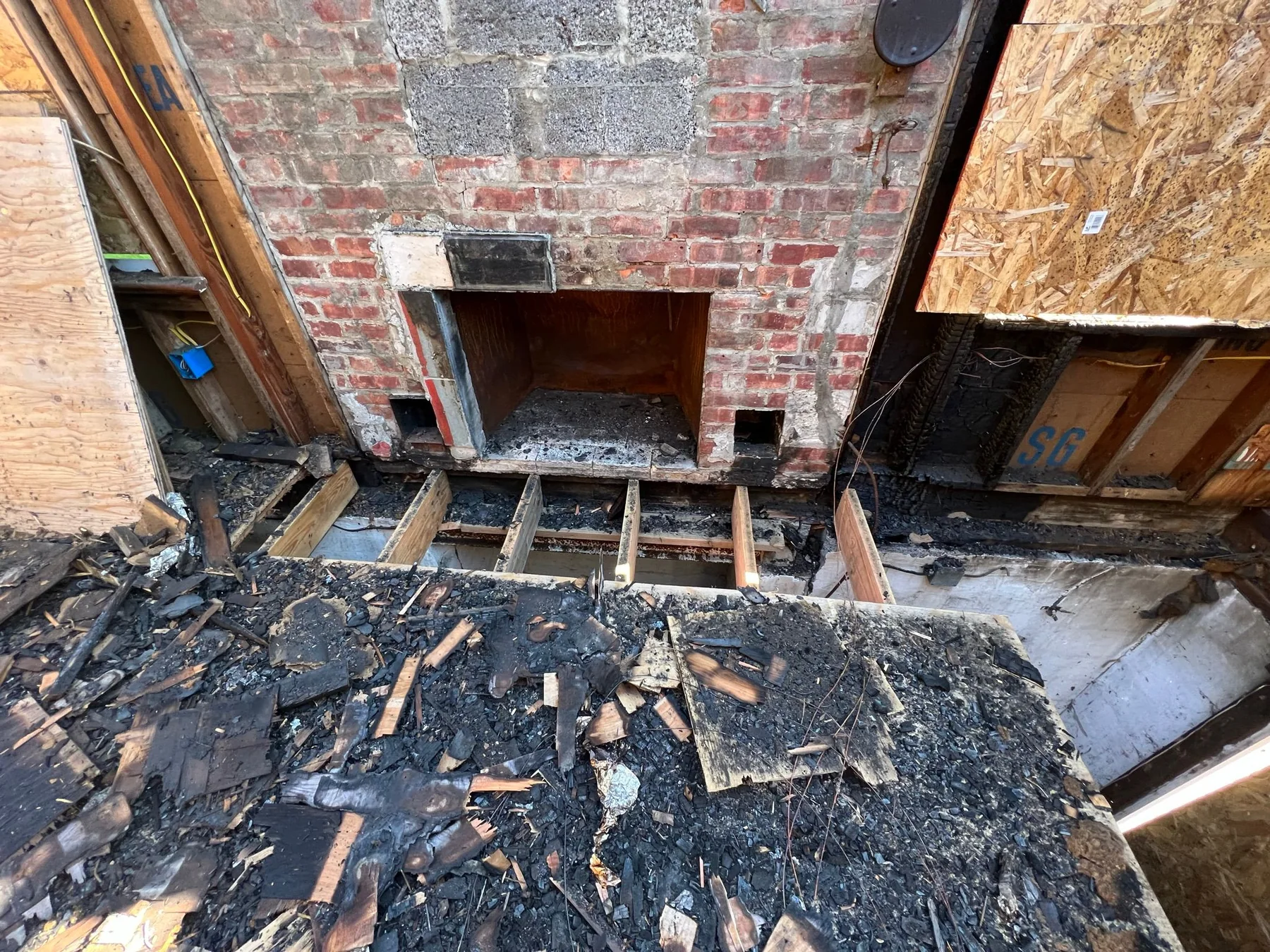 Damaged floor framing at fireplace