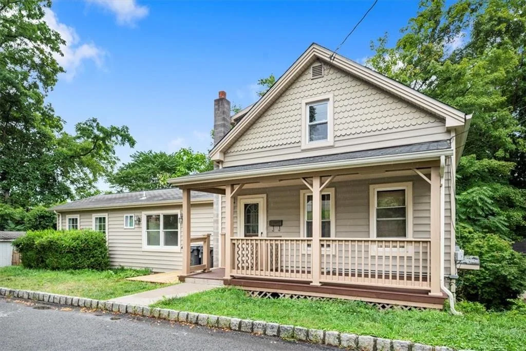Angled front exterior view with covered porch