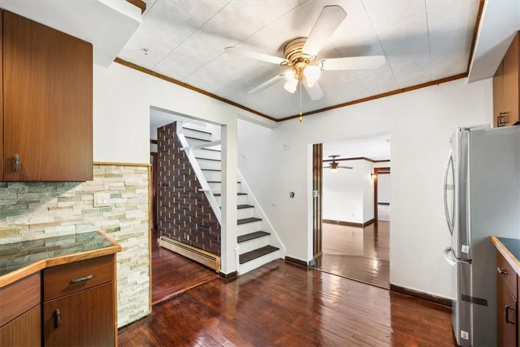 Kitchen and stair connection with finished wood flooring