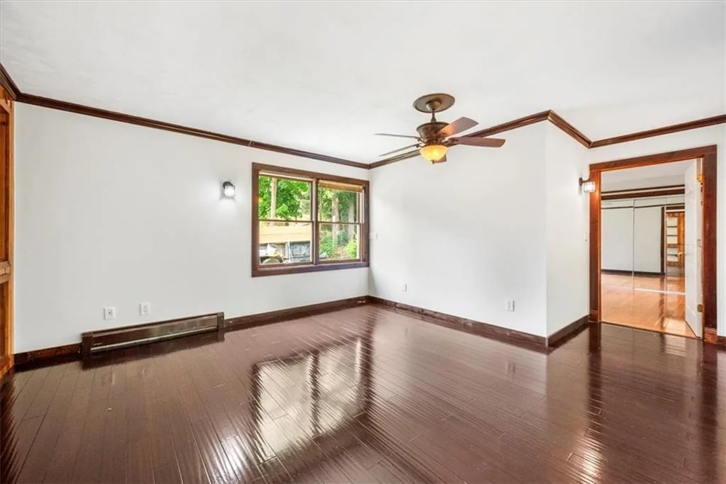 Completed living room with polished dark wood flooring