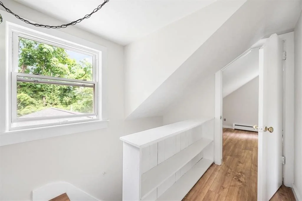 Upper-level landing with built-in shelving and window