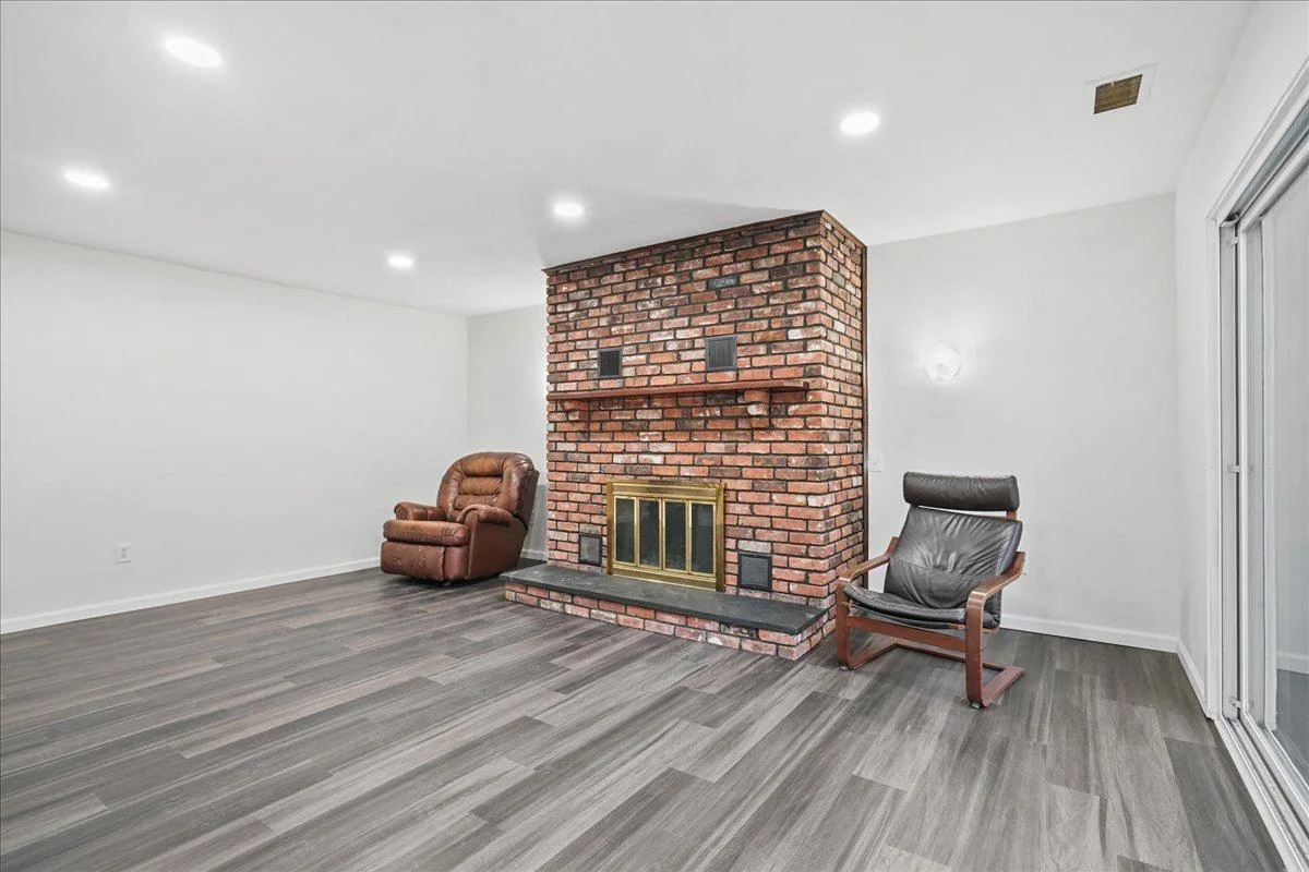 Completed living room with brick fireplace