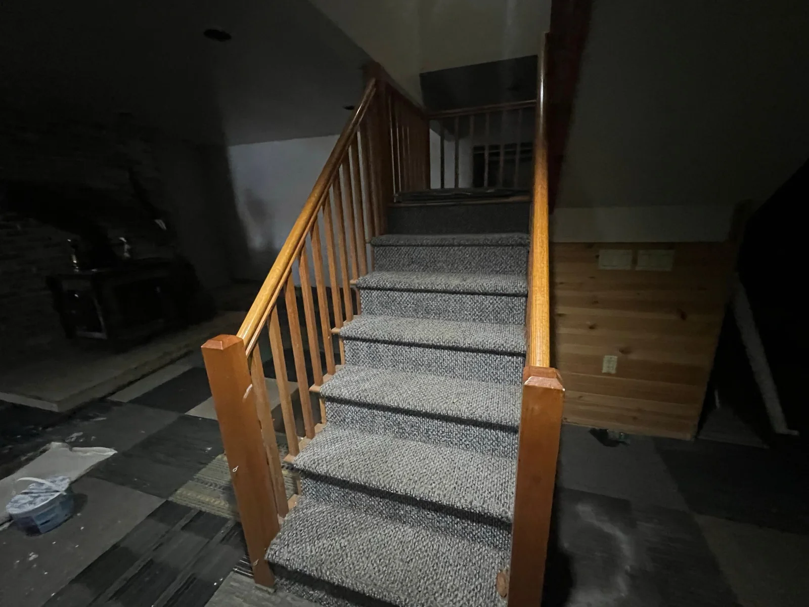 Worn carpeted stair before rehabilitation