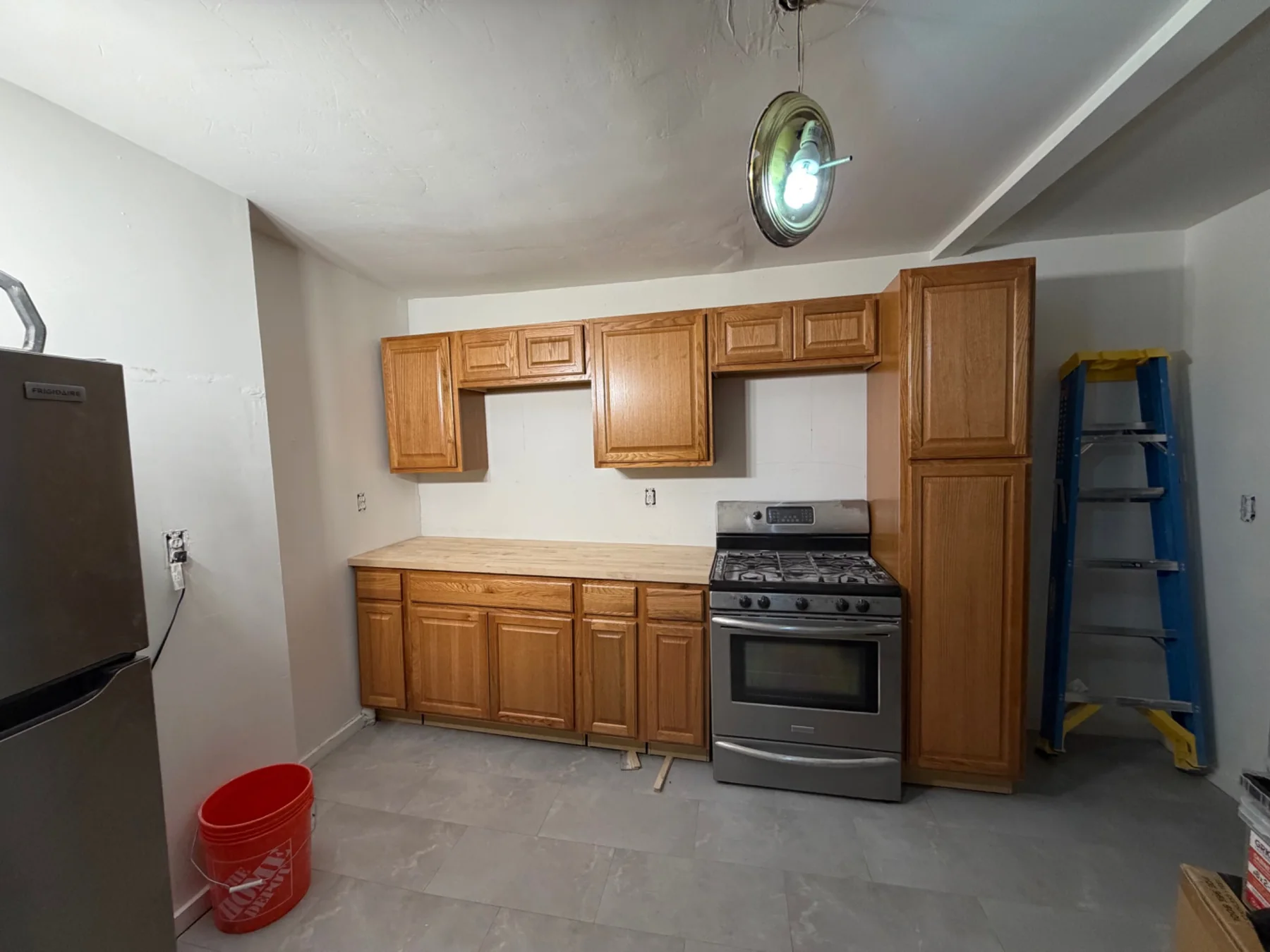 Kitchen fit-out in progress with cabinetry and appliance placement