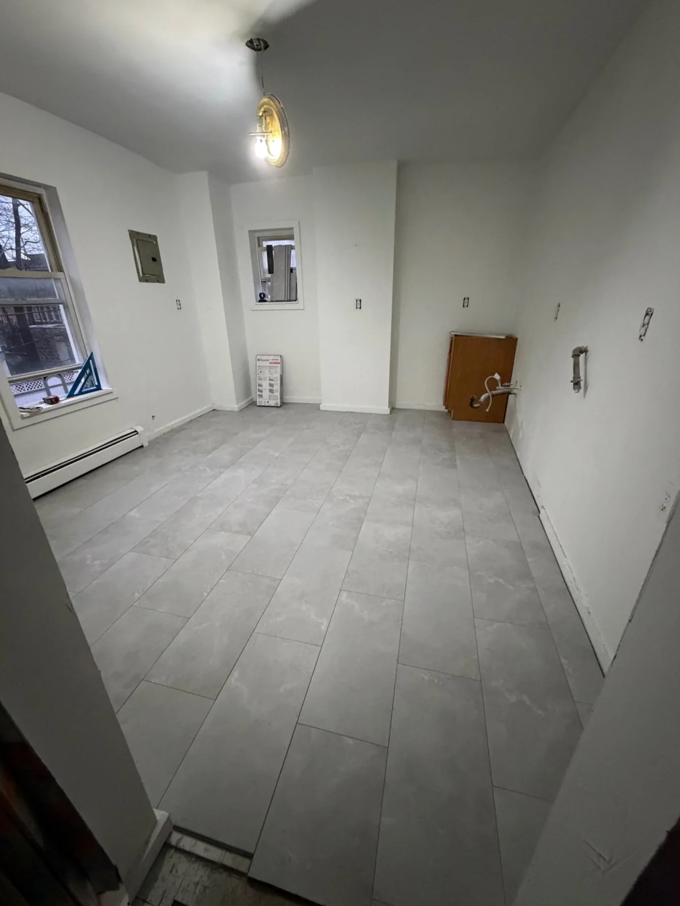 Tiled kitchen floor and room layout during construction