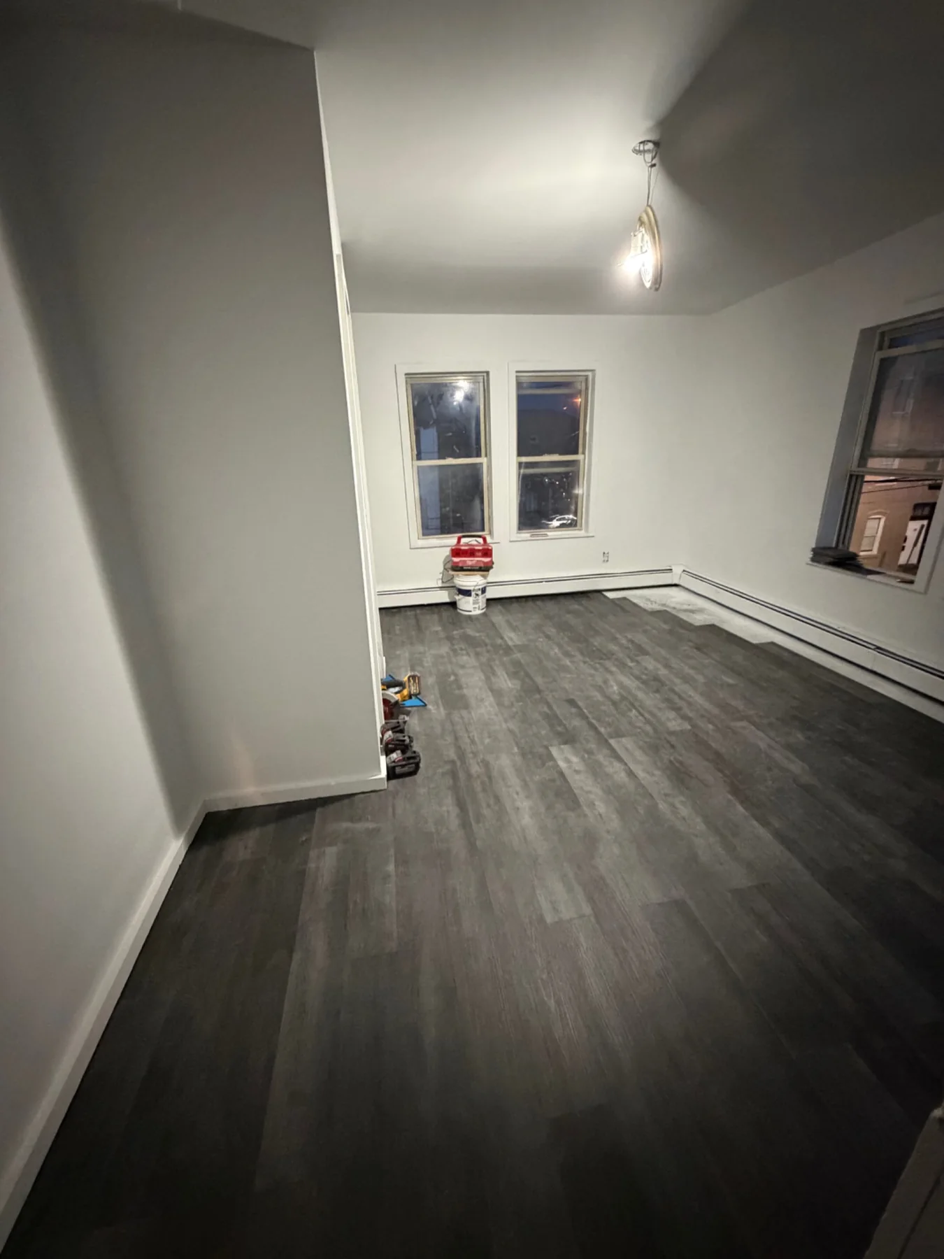 Finished living area with new dark flooring and refreshed wall surfaces