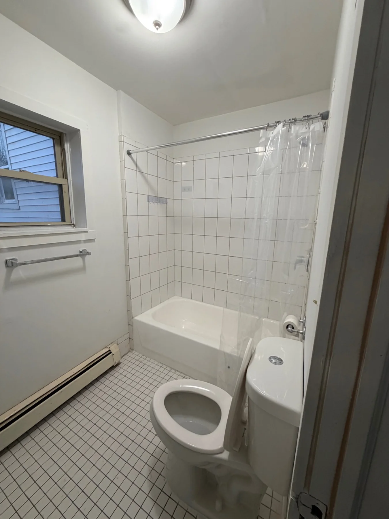 Completed second-floor bathroom with tiled tub surround