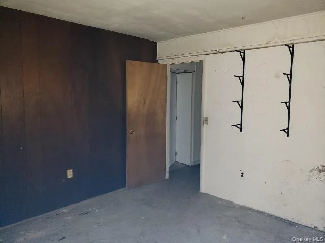 Bedroom with wood wall before