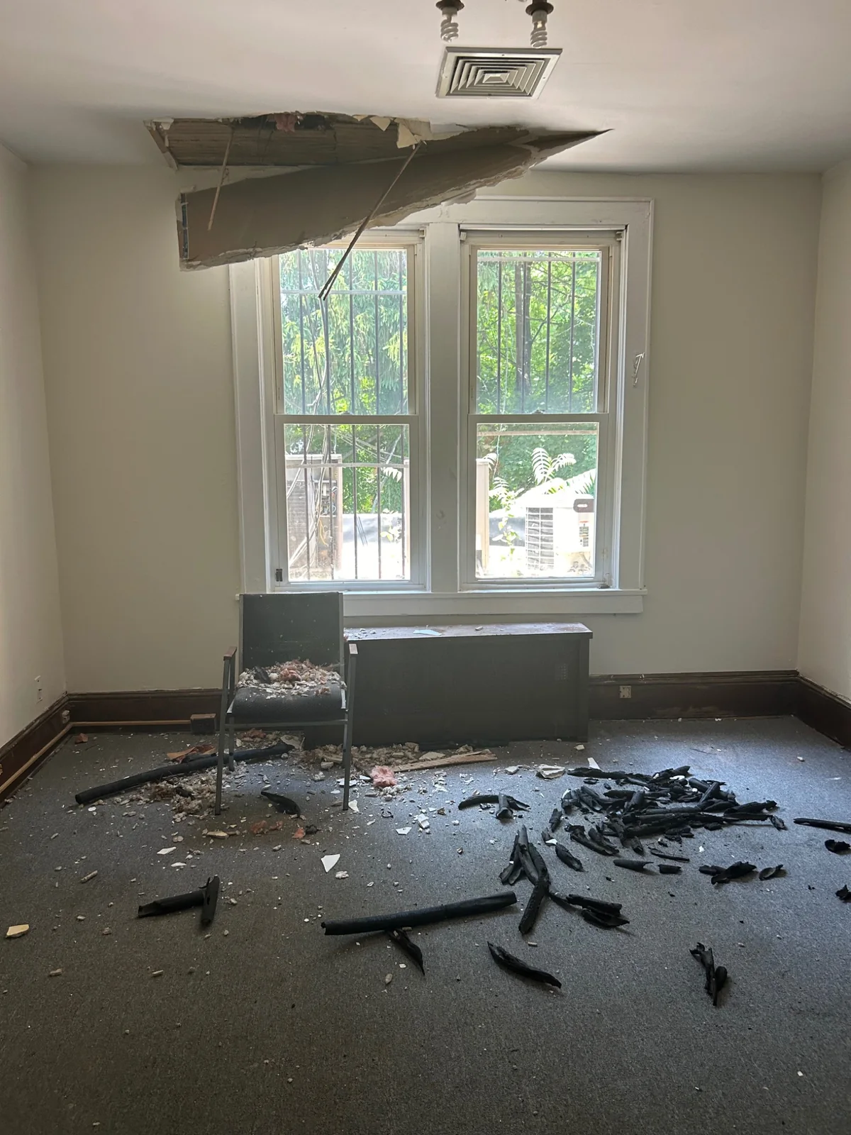 Interior room with damaged ceiling and debris