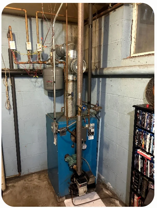 Older boiler and hydronic piping before modernization